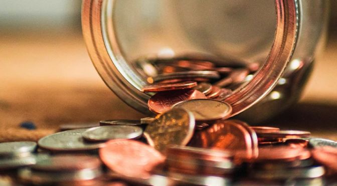 image of coins spilling out of jar